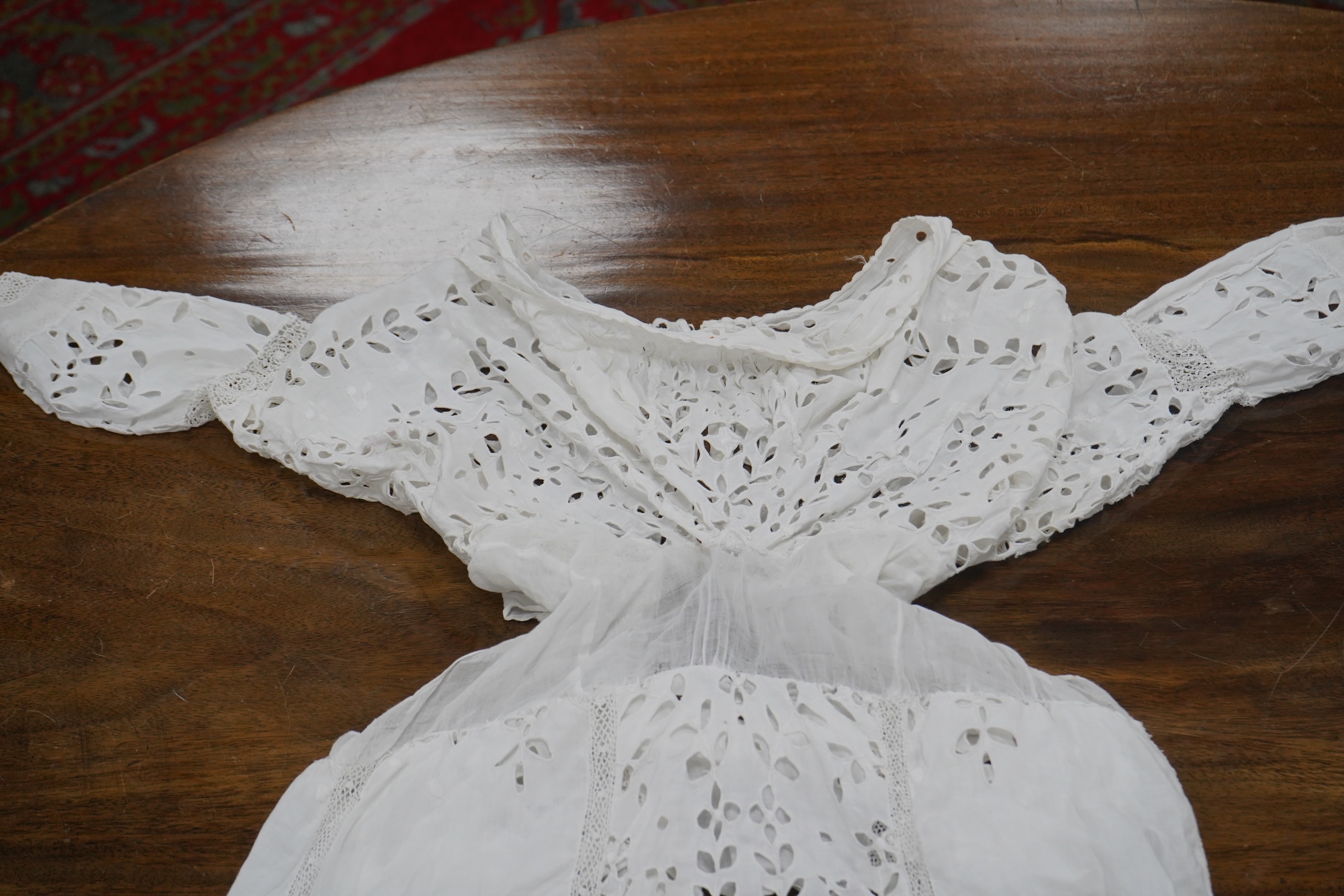 An Edwardian fine white embroidery anglaise and Irish crochet trimmed ladies summer dress, designed with large panels of anglaise cut work, the dress has been altered and restyled, which could be altered back, 134cm long